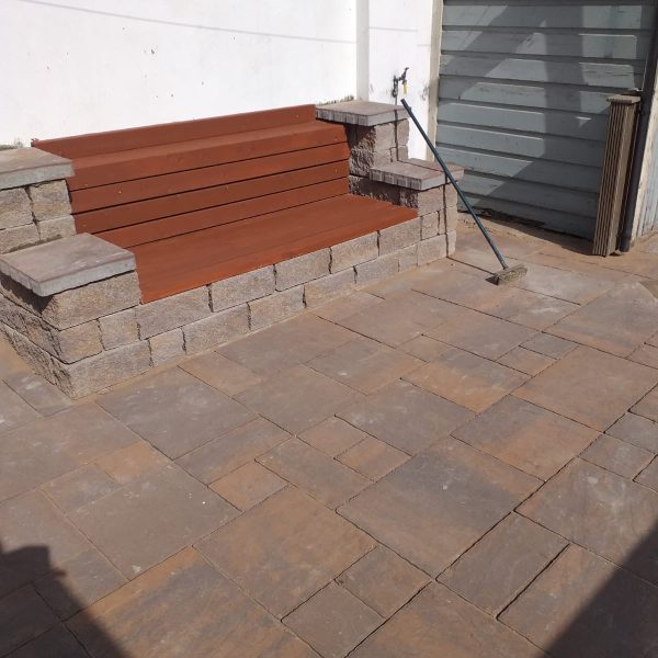 Garden bench made from wood and matching stone foundation